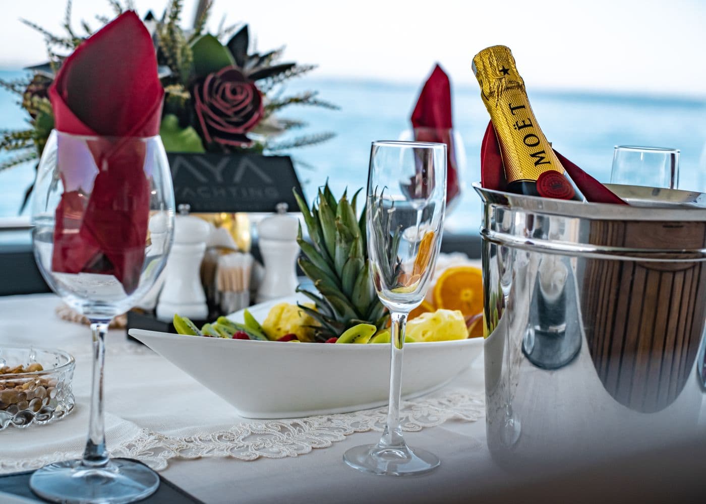 An elegant table set on deck overlooking the sea