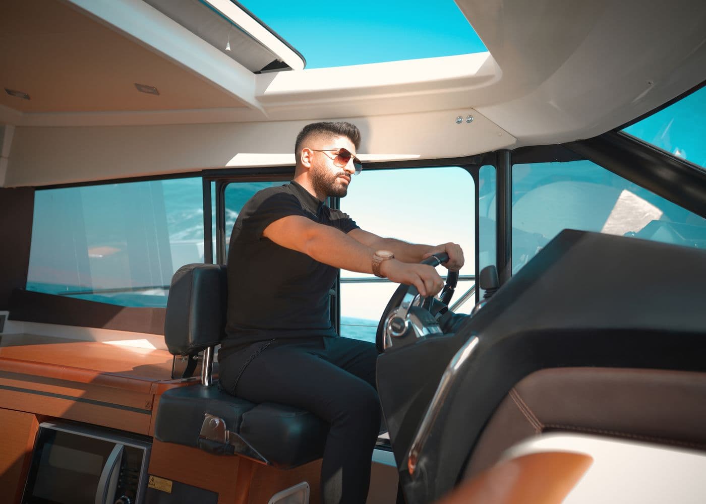An operator at the helm of their own boat off the coast